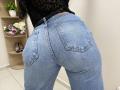 OliviaGranda's tight blue jeans highlight her big ass, with visible pockets and a black lace top. Her belt's slightly loose, showing a tan leather strip.