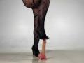 CelesteMorel's legs in black lace fishnet stockings and black high heels, standing on a realistic pink dildo with a visible cockhead.