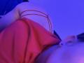 HornnyCoupleHot's ass in red strappy lingerie, shot from below with blue lighting. Red top, visible ear with stud, and red straps on their back.