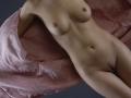 KamiLove's naked body with small tits, flat stomach, and a trimmed pussy, draped in pink, semi-transparent fabric. Her skin is pale and smooth.