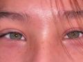 MarybelleDoerr's face, focused on her green eyes, with pinkish skin, slightly parted brown eyebrows, and a few freckles, with pink hair strands partially covering her eyes.