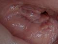 AuroraStar's wet, glistening pussy with visible folds and a small clitoral hood. The image focuses on the intimate, moist skin textures and natural pinkish hues.