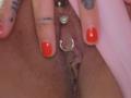 FrenchShanna's pussy with red nail polish, a ring in the clitoral hood, and a gem in the upper lip. Her fingers are spread, showing tattoos.