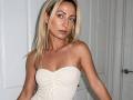 ViktoriiaLu has blonde hair, blue eyes, and is wearing a strapless white textured top that shows her small, firm tits. She's standing in a white room.