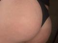 Barbarica's butt in black underwear, showing a tight buttcheek with visible skin creases and a slight tan line. Her skin is pale with some redness.